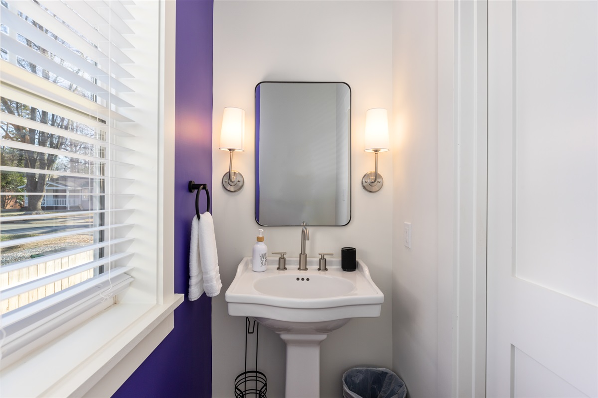 The main floor half bath is conveniently located just off the open concept living room and near the double twin main floor bedroom.