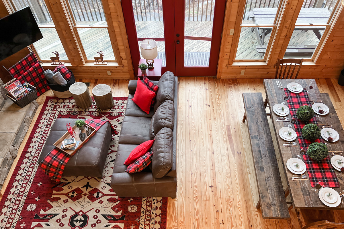 Soaring great room with a dramatic wall of windows bringing the surrounding mountain scenery right into the cabin.