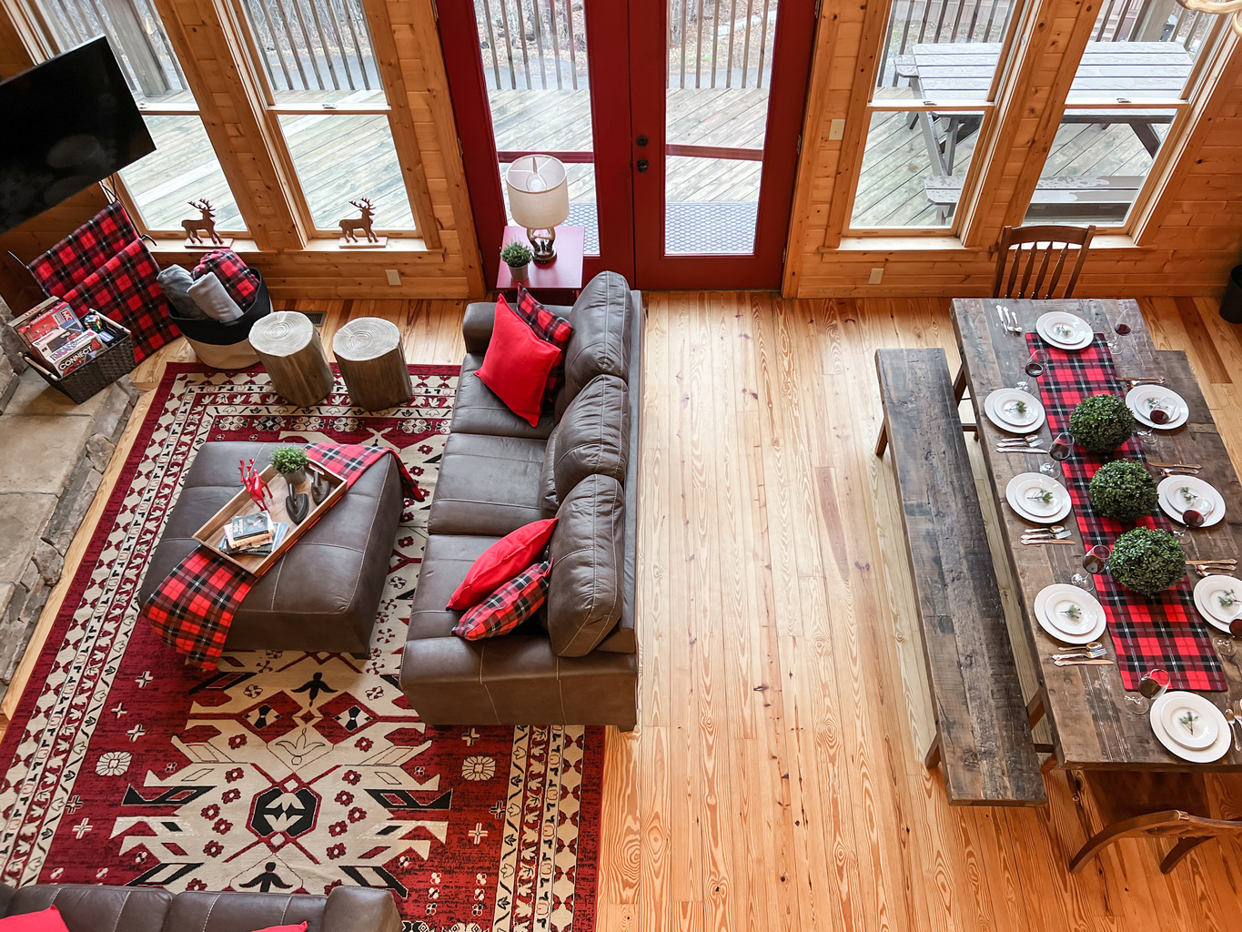 Soaring great room with a dramatic wall of windows bringing the surrounding mountain scenery right into the cabin.