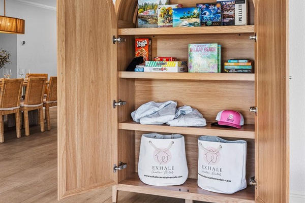 Charming built-in cabinet stocked with games, books, and beach essentials