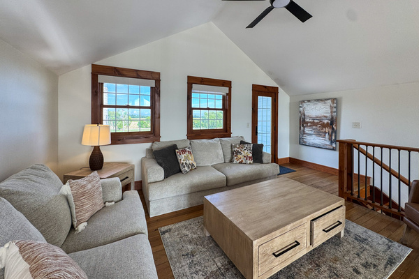 Upstairs loft seating with access to the front balcony.