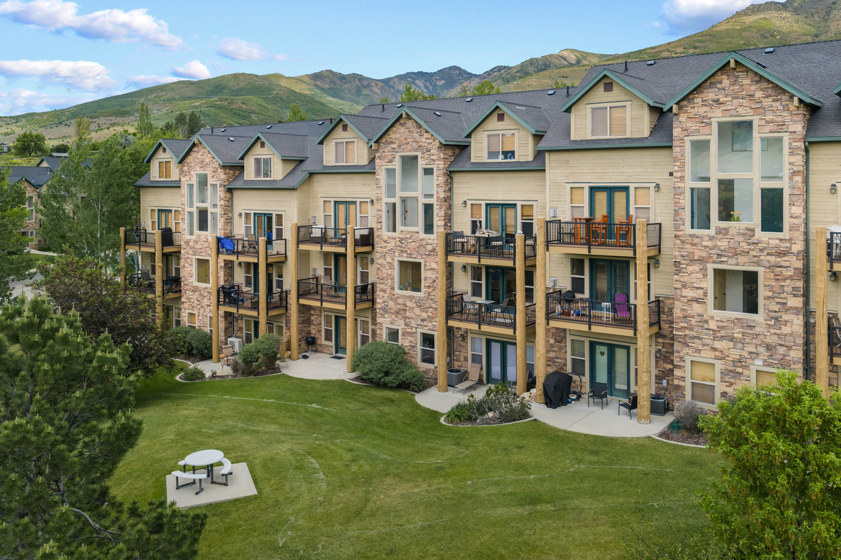 The patio offers a peaceful scene with sunshine, peaks, and a perfect spot for grilling or gathering.