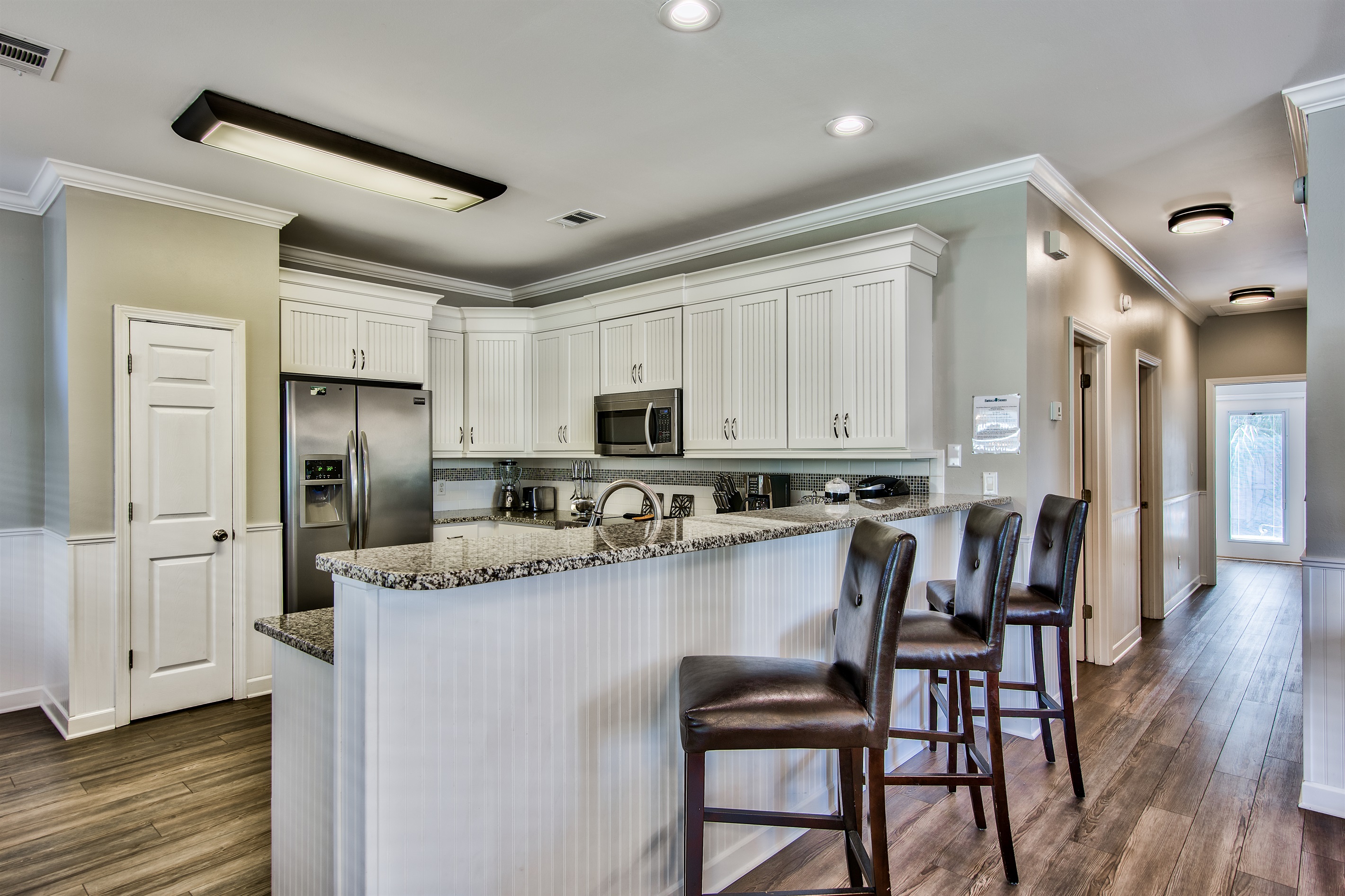 Fully stocked kitchen with stainless‑steel appliances and granite countertops