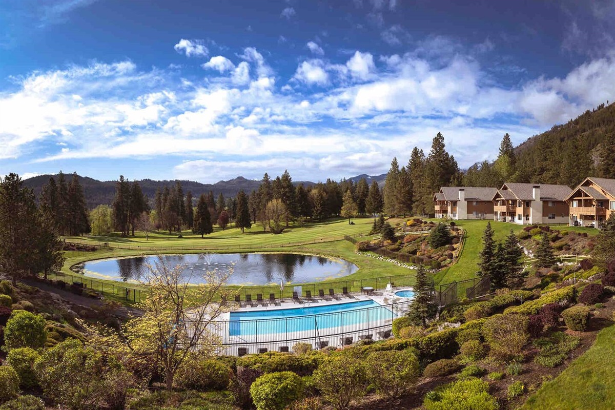 Summer view from the balcony of the pool, pond, and golf course. 