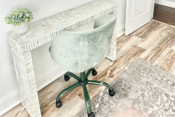 Find a quiet moment at this stylish workspace, with a unique patterned desk and a comfortable velvet swivel chair. Whether you need to catch up on emails or plan your next day's adventure, this bright corner provides a dedicated spot to stay productive.