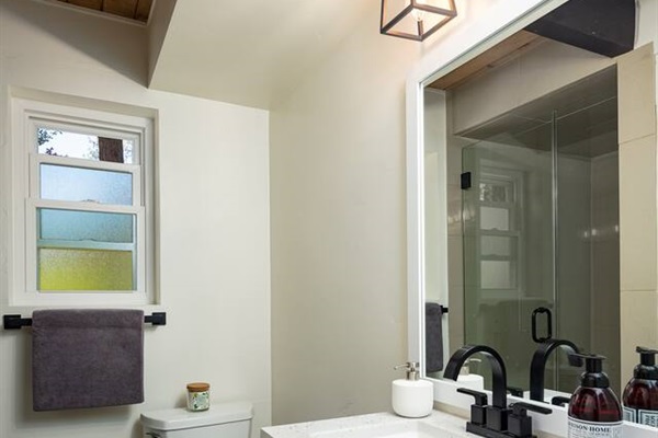 Second bath has a large tile shower, a bidet, and  lots of storage.  A hairdryer and makeup mirror are provided, along with towels, washcloths, and hand towels.