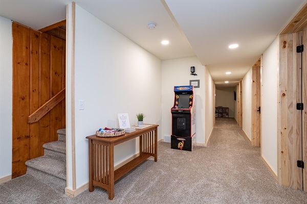Lower-level hallway with the TV room at the end. We also have a retro arcade with games like packman and Galaga in the hallway. Bed 3 is behind this pic with bed 4 to the right and bed 5 down the hallway.
