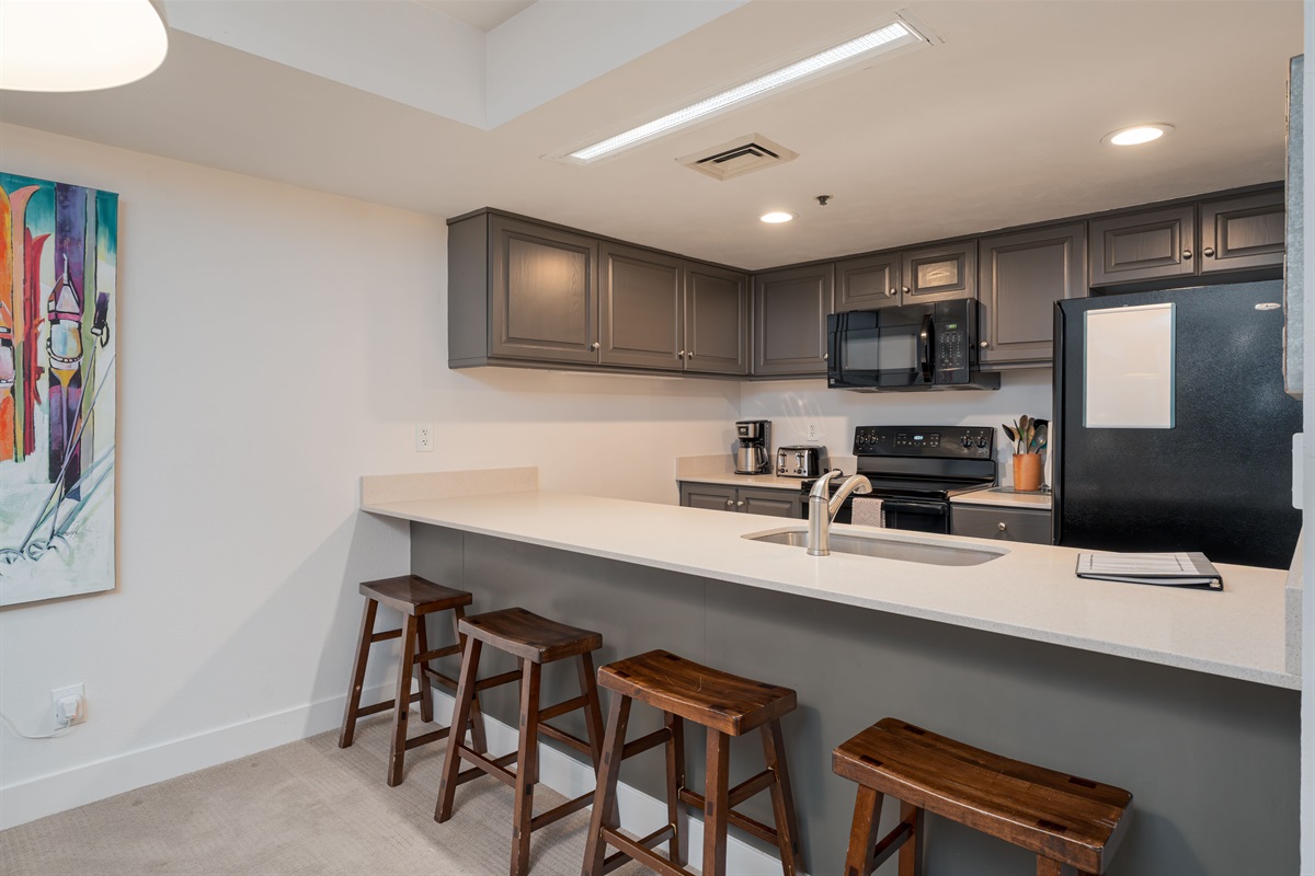 Bar seating between kitchen & dining area.