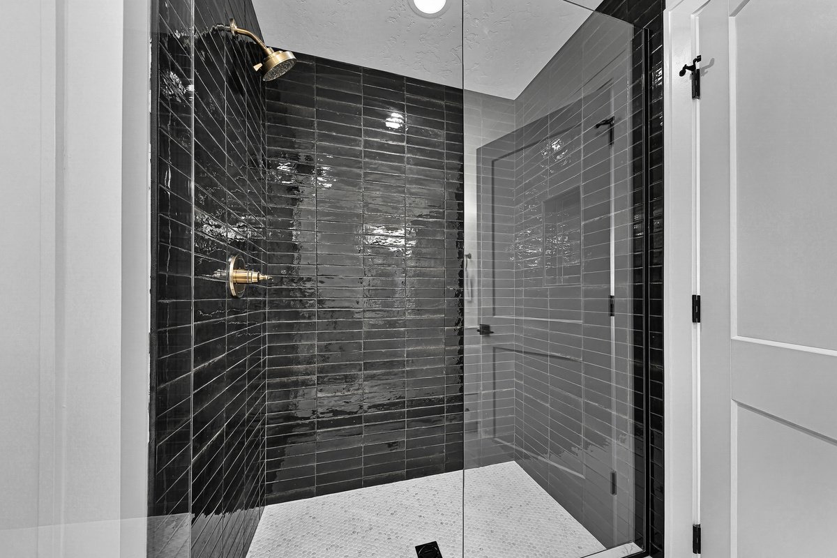 3rd floor bedroom with king size bed ensuite bathroom with shower and dual sink vanity