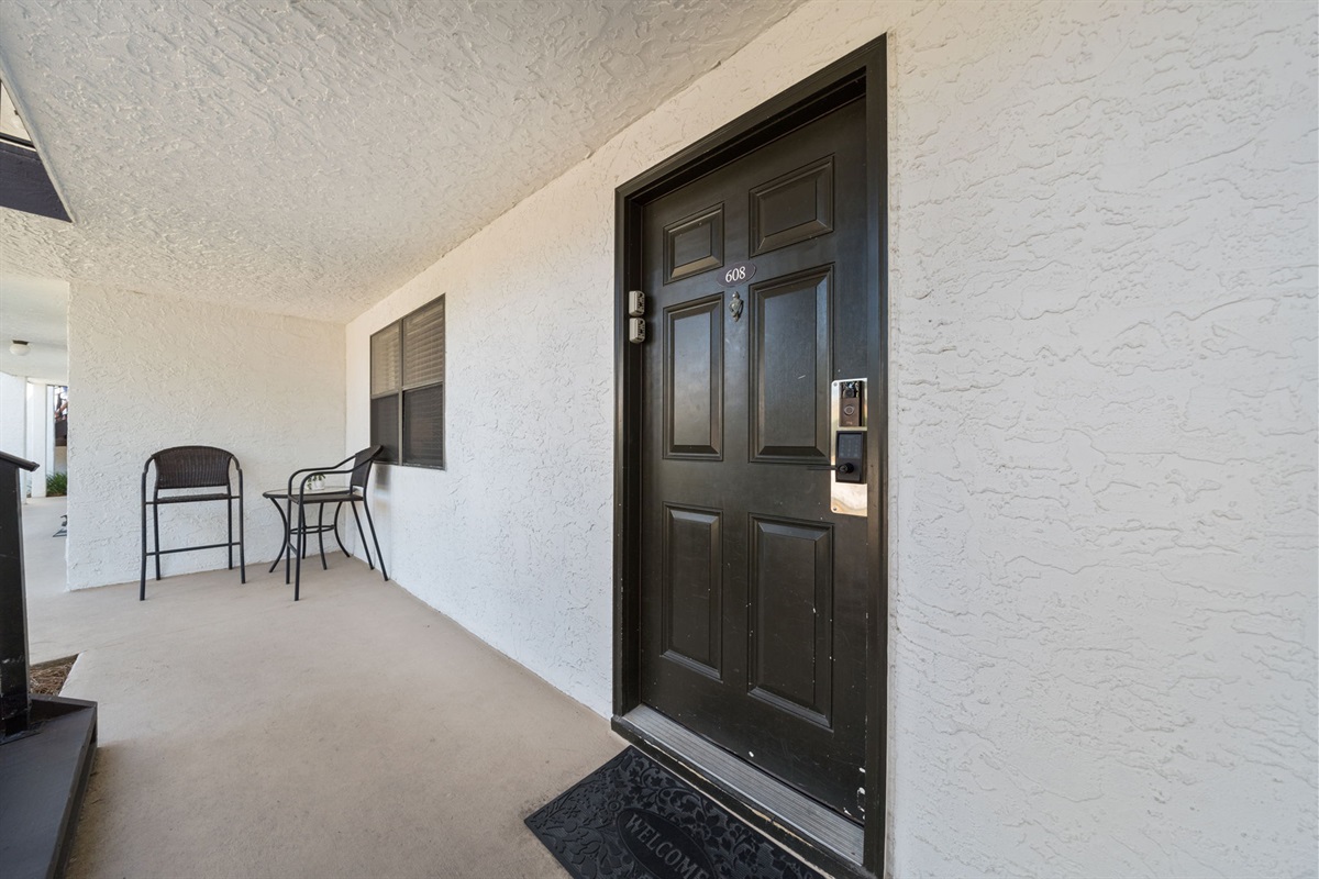 Our open front walkway includes 2 high-top chairs and a table for a casual chat or visit