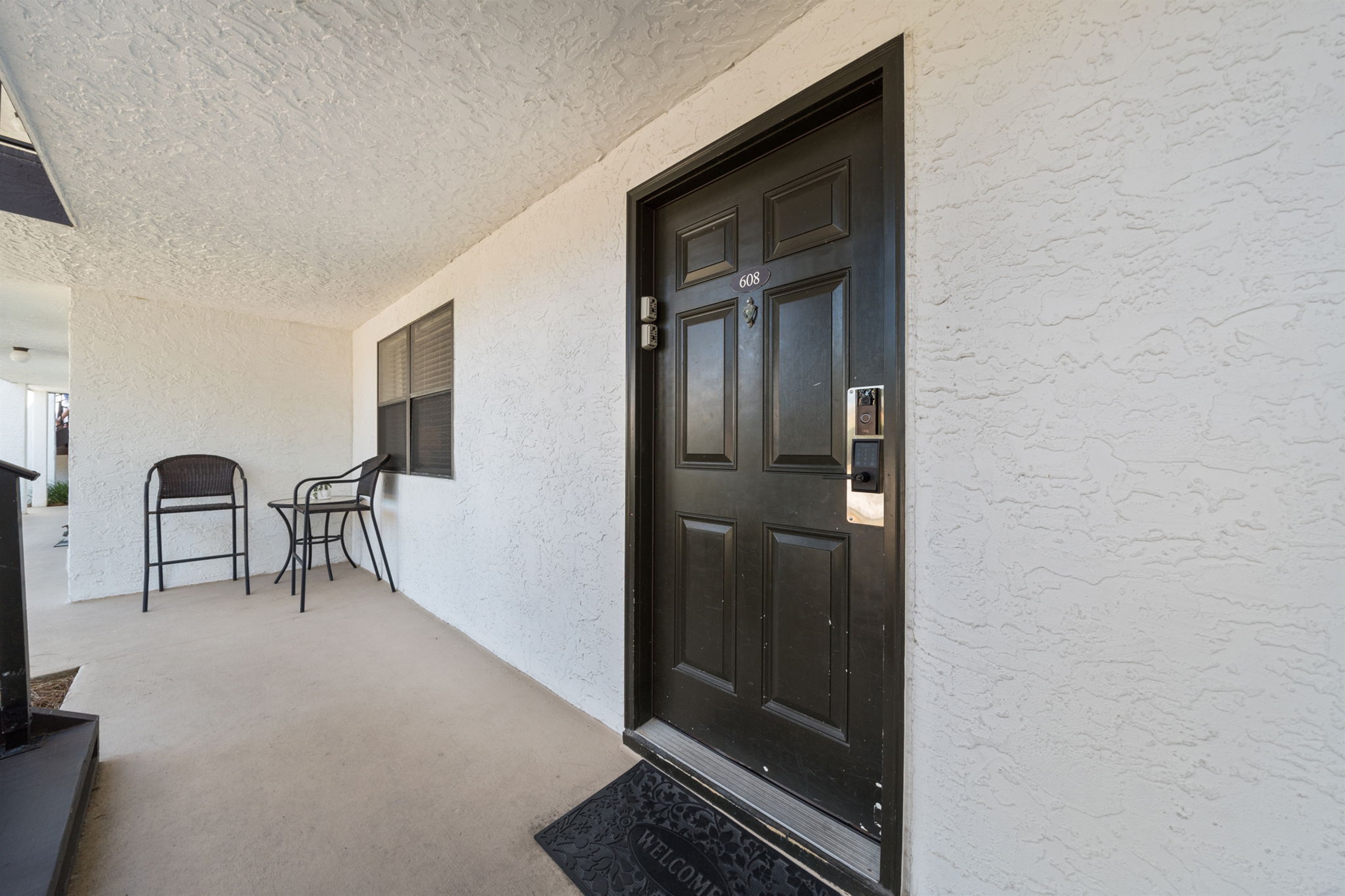 Our open front walkway includes 2 high-top chairs and a table for a casual chat or visit