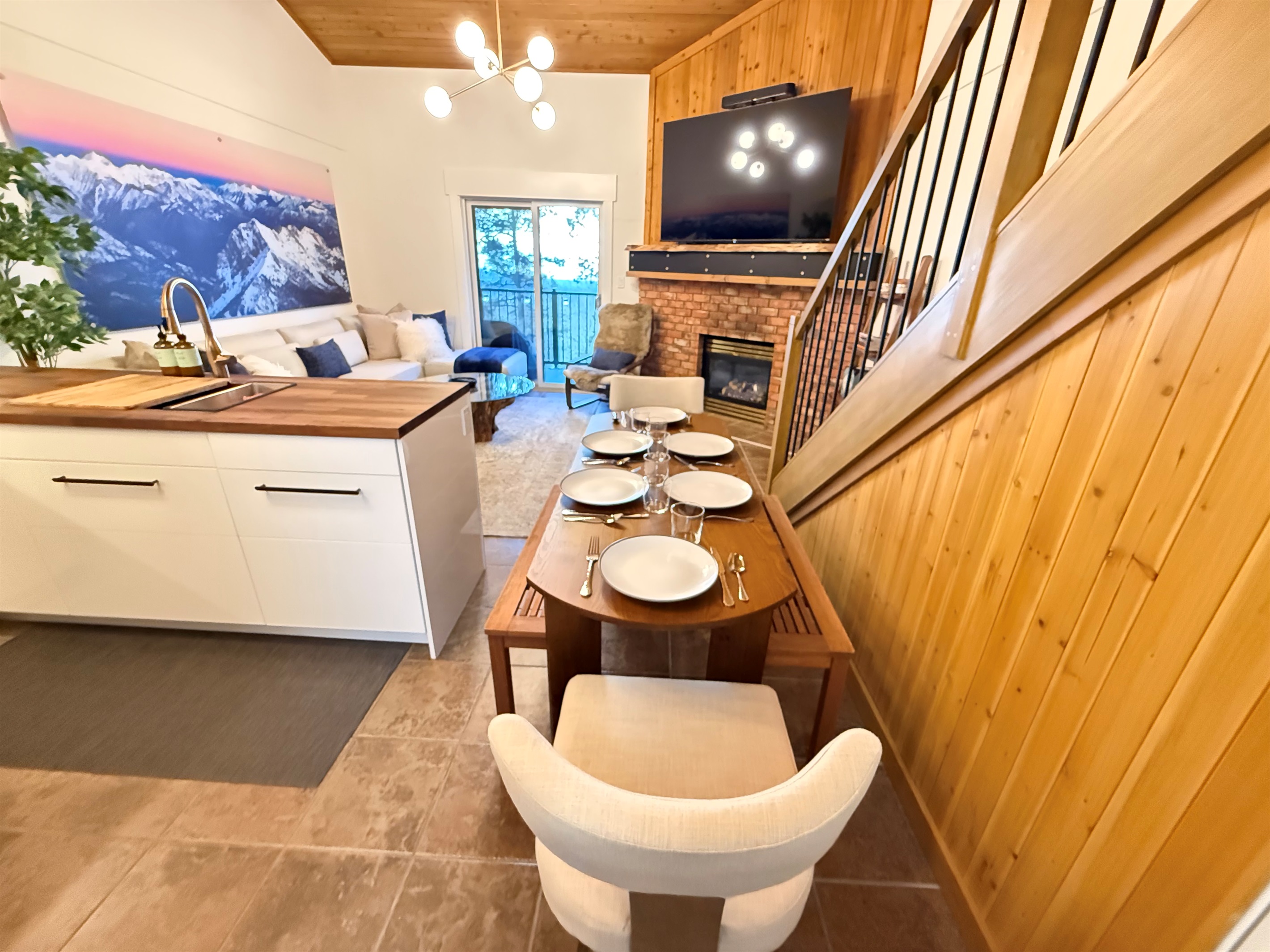 Flexible Dining for 6: The dining area offers flexible seating for four, and as shown, easily accommodates six guests by utilizing the entrance bench. Perfect for group meals.