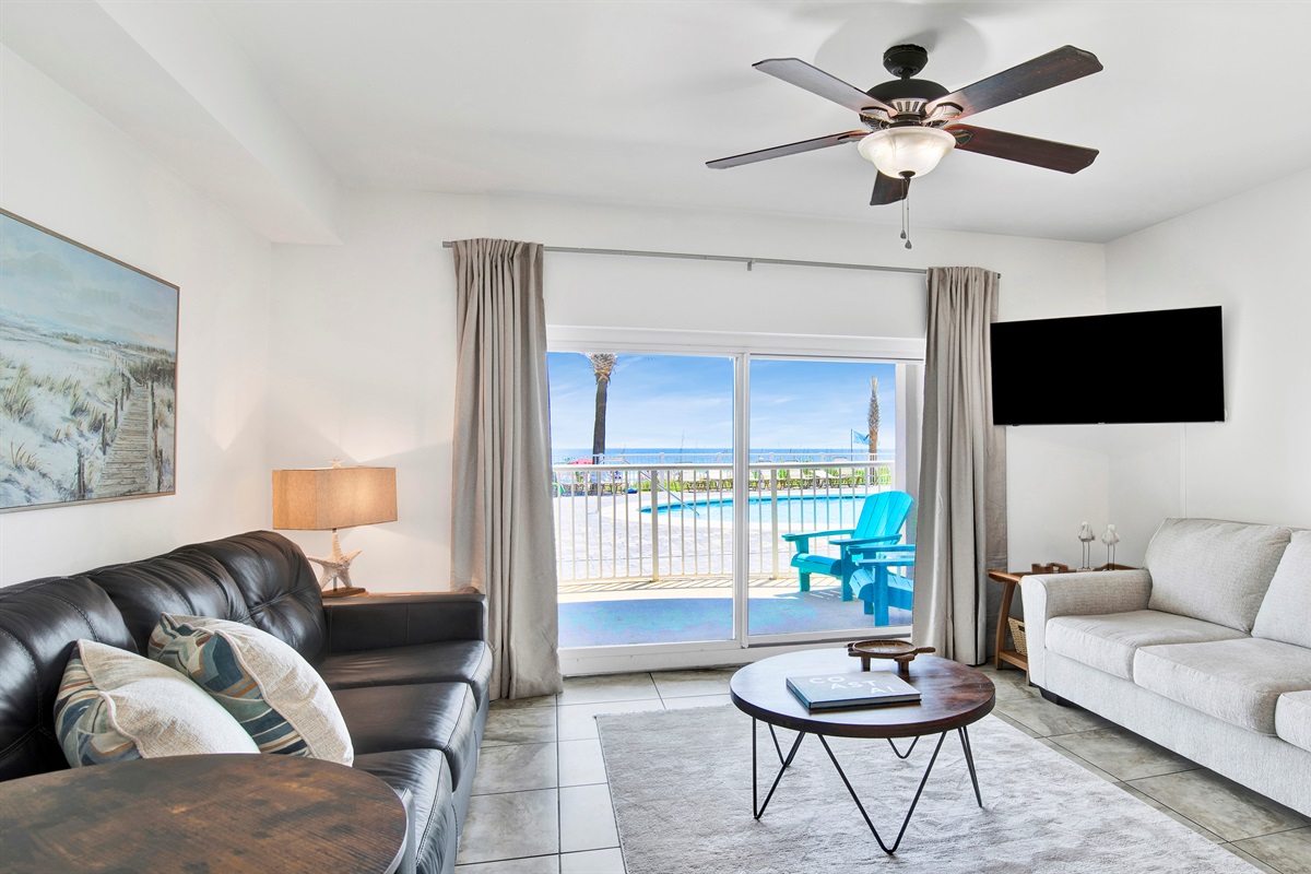 Living room with sleeper sofa, a 2nd sofa, smart TV, ceiling fan and balcony access
