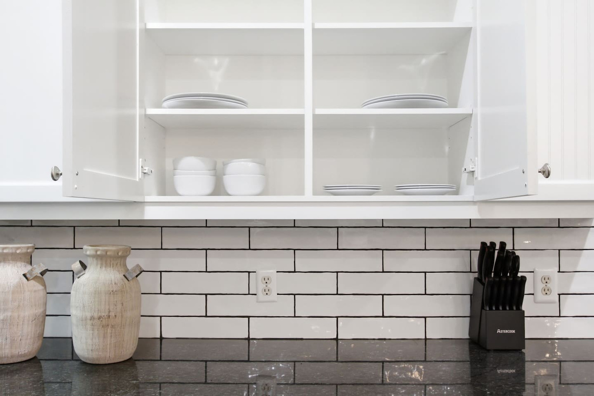 Open shelving stocked with dishware, cookware, glassware, and kitchen basics. Fully equipped for group meals, coffee mornings, and everything in between throughout your stay.

