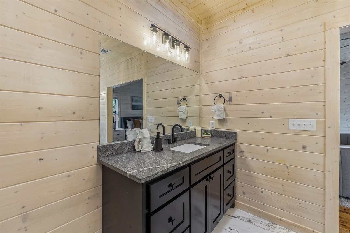 Soft natural light and warm wood accents make this vanity feel calm and inviting, with forest views that add a touch of serenity.