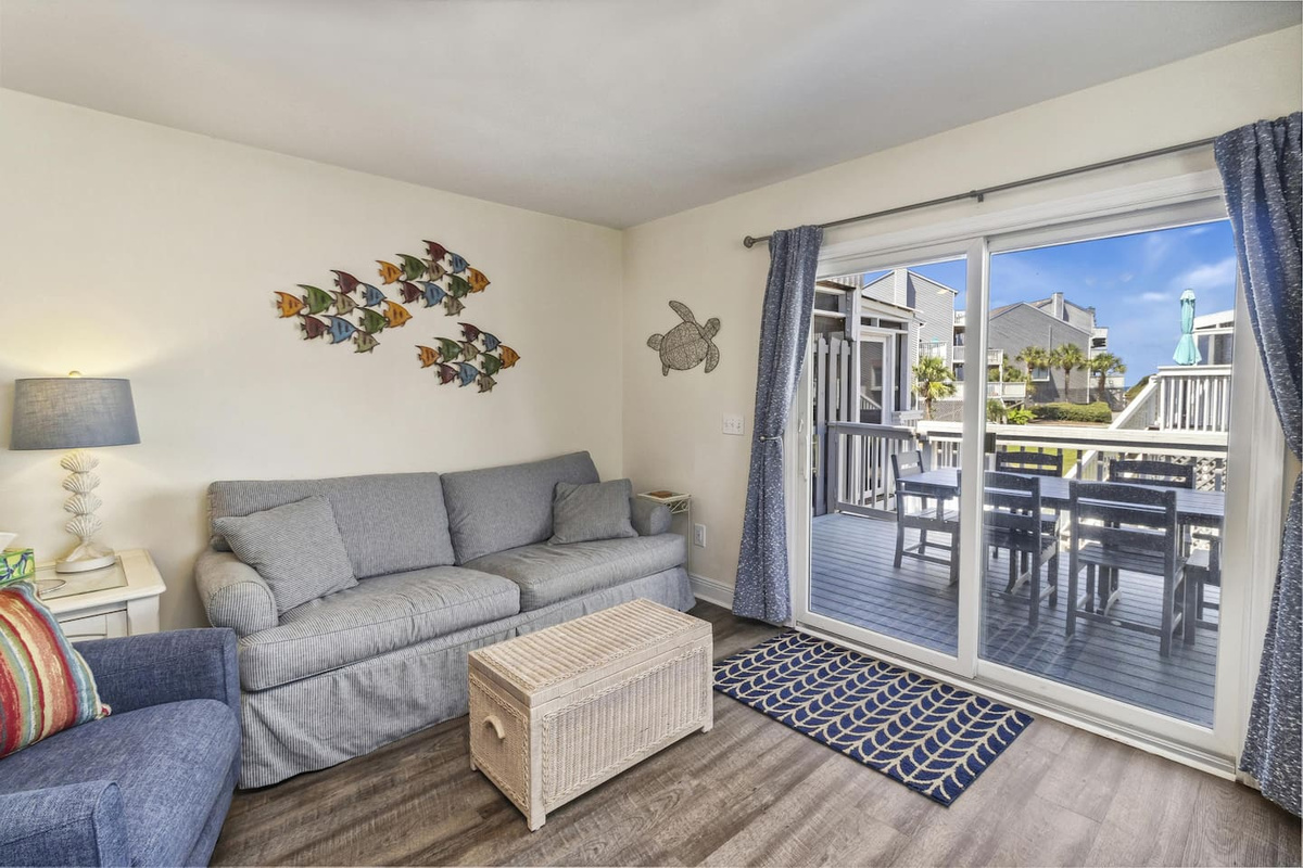 Gather in the main-level living room &mdash; the Gulf view deck is just steps through the glass doors.