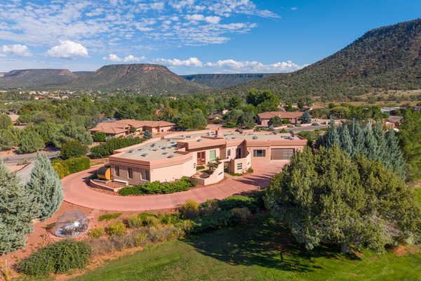 Private luxury retreat with circular drive, lush golf course frontage, outdoor barrel sauna, and a cozy stargazing dome.
