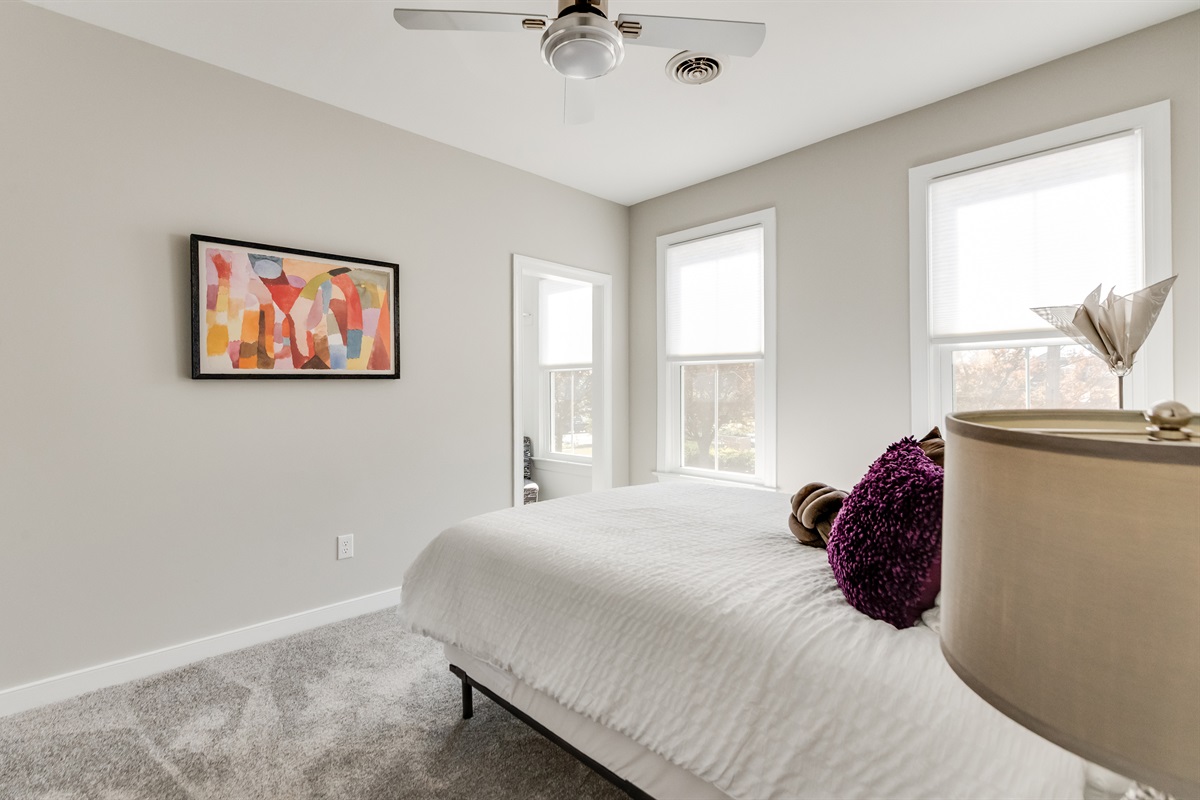 Queen Bedroom 3: Sunlit room with plush textures and vibrant art for ultimate relaxation!