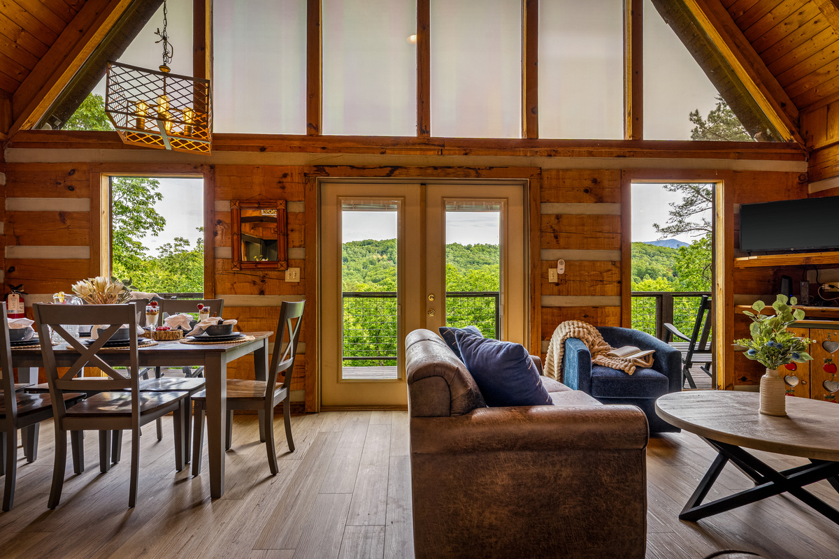 The open-concept main level family room offers a dining table, comfortable seating, and a smart TV
