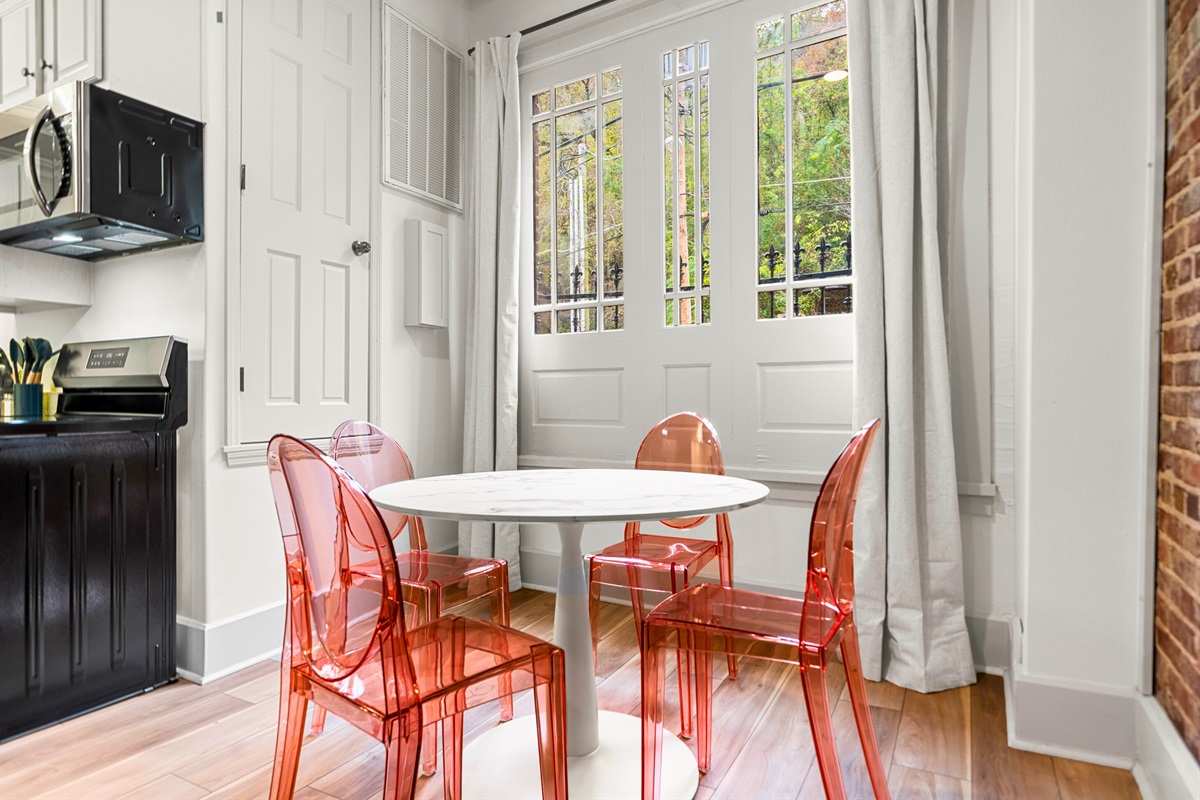 The charming dining area is bathed in natural light, creating the perfect setting for a relaxed meal or conversation.