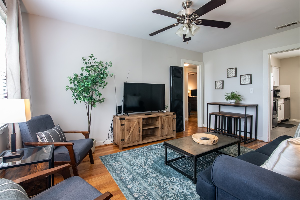 Alternate view of the bright living room with open layout and thoughtful decor touches.