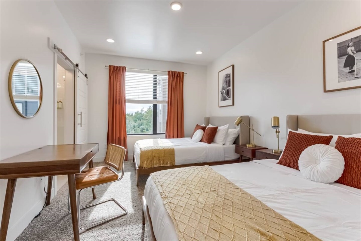 The primary bedroom is warm and inviting, with an ensuite bathroom and walk in closet.