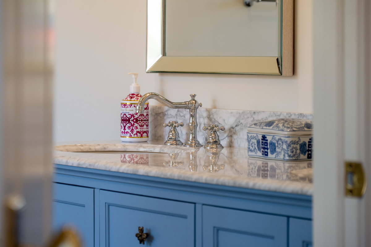 Classic polished fixtures, and carefully selected accents bring a sophisticated finishing touch to this thoughtfully designed bathroom.