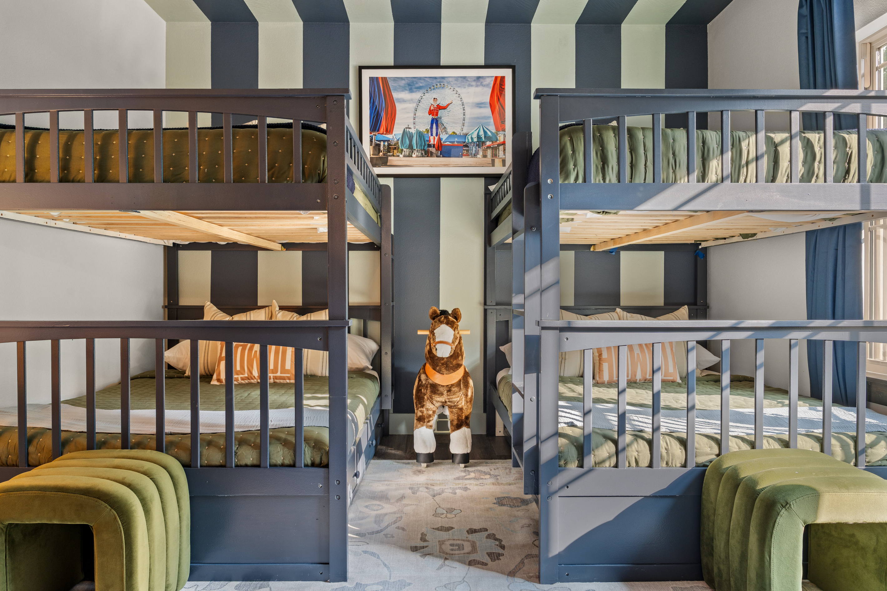 Two sets of bunk beds face off in a playful room built for siblings, cousins or friends.