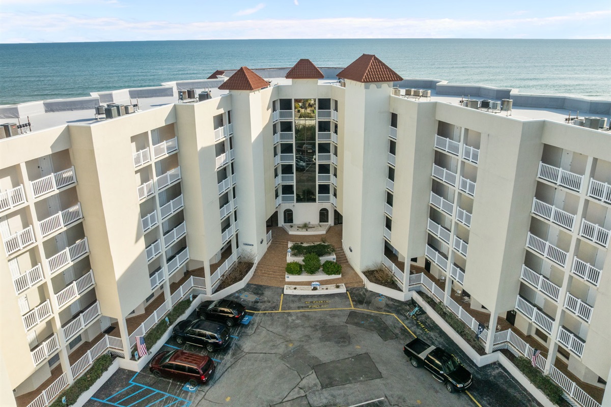 Main courtyard and front entrance of St. Regis Building 1, with elevator access and landscaped walkways