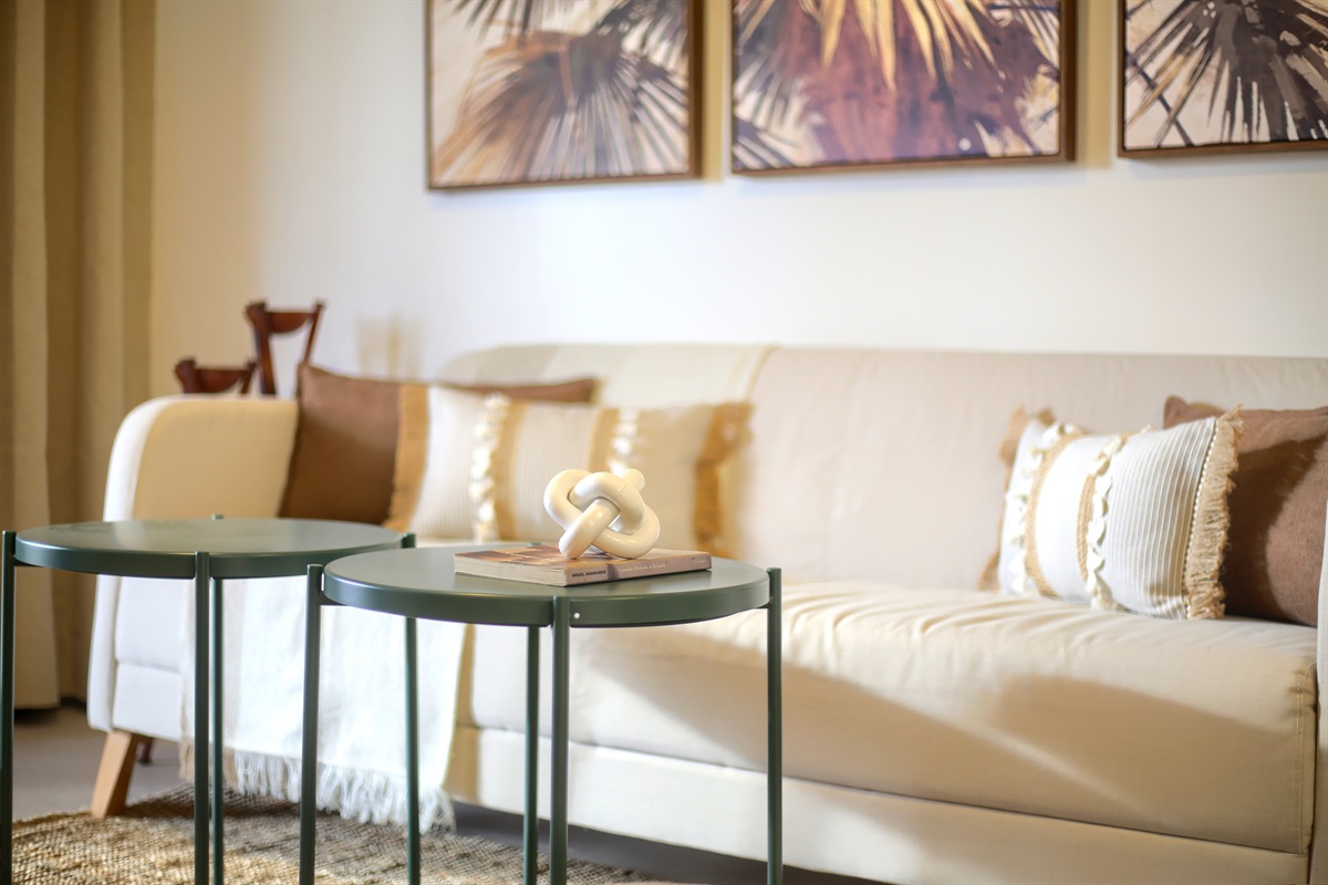Cosy seating area with a comfortable sofa and carefully selected decorative touches - a perfect spot to unwind.