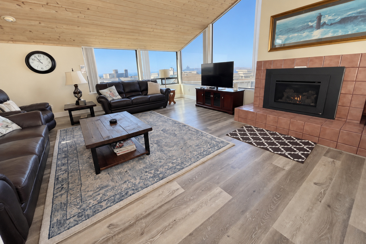 Living Room couches face large picture windows with view of Pacific Ocean and Doran Beach