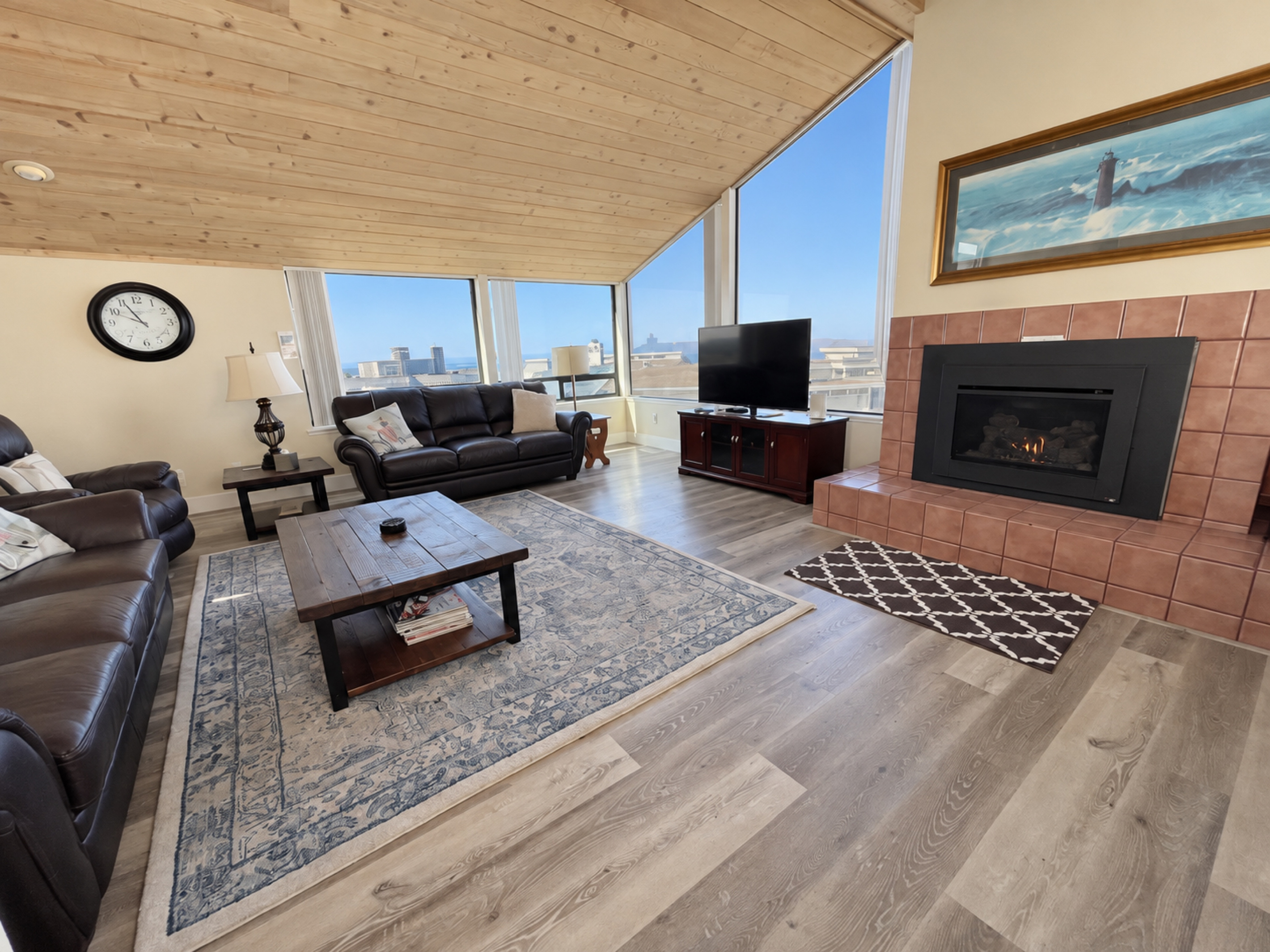 Living Room couches face large picture windows with view of Pacific Ocean and Doran Beach