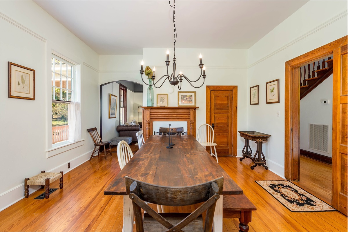 Spacious dining room with farmhouse table and firelogs