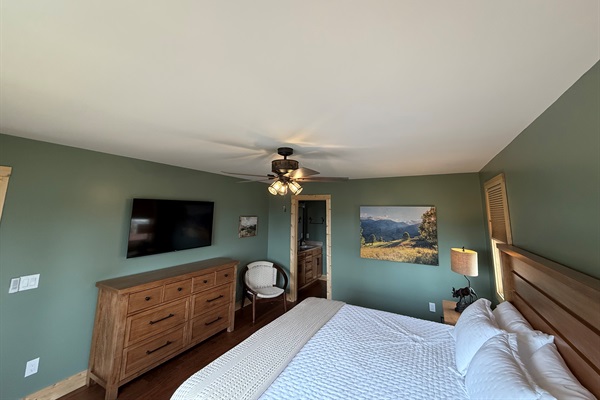 Primary Bedroom w/ king bed and TV.