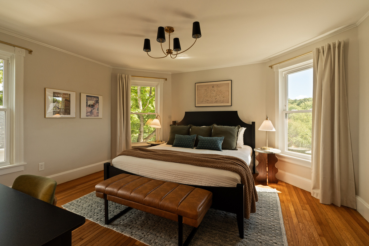 Your primary suite. A spacious, inviting retreat with a king bed, beautiful natural light, and plenty of room to settle in and unwind.