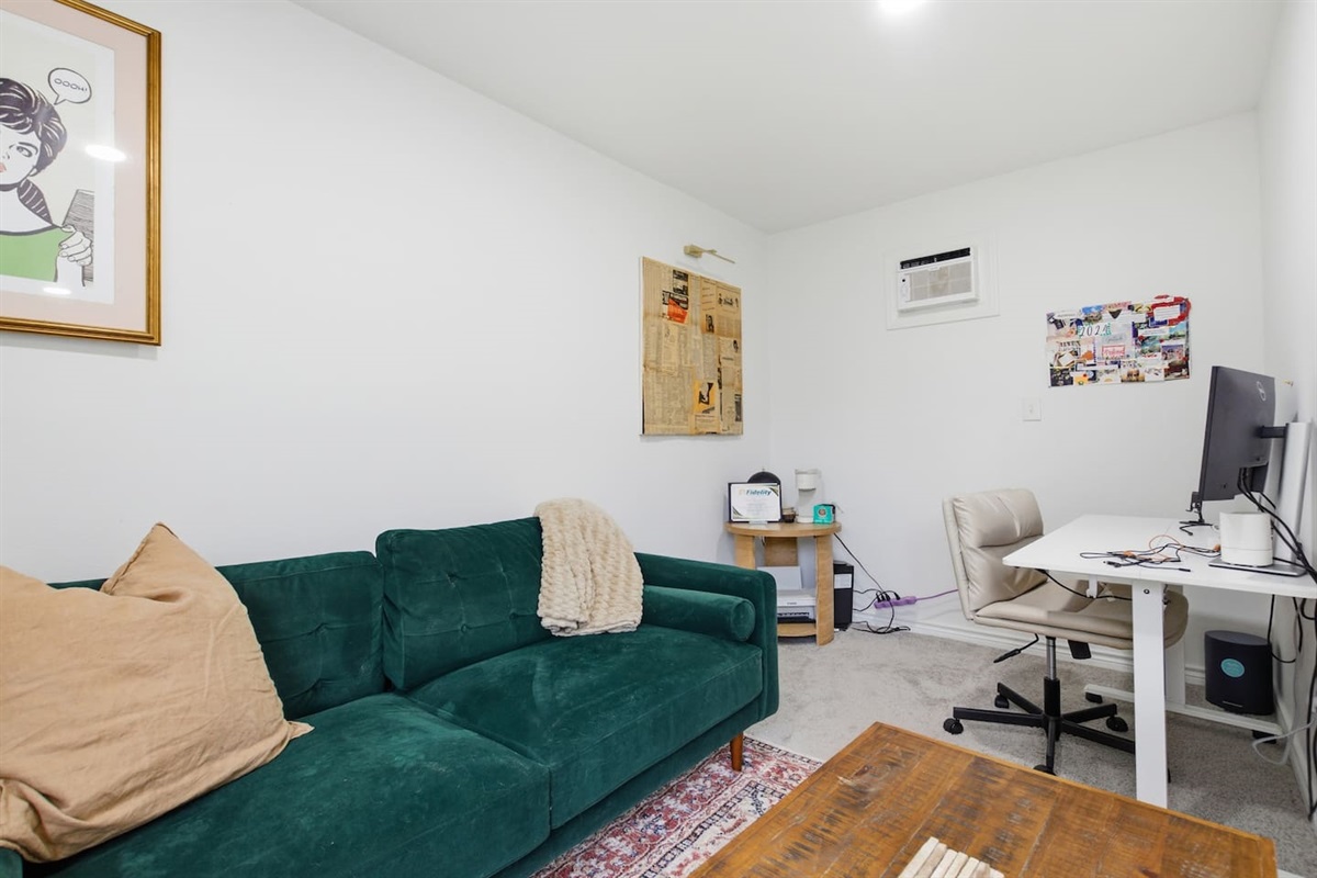 Private office lounge with sofa seating, coffee table, and a pull-out sofa futon that sleeps one person comfortably (single size), perfect for work or relaxation.
