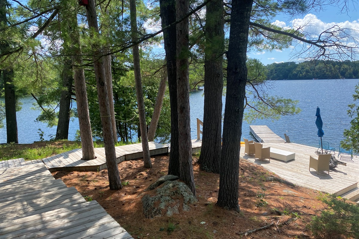View of dock area, deck and steps down to water from cottage