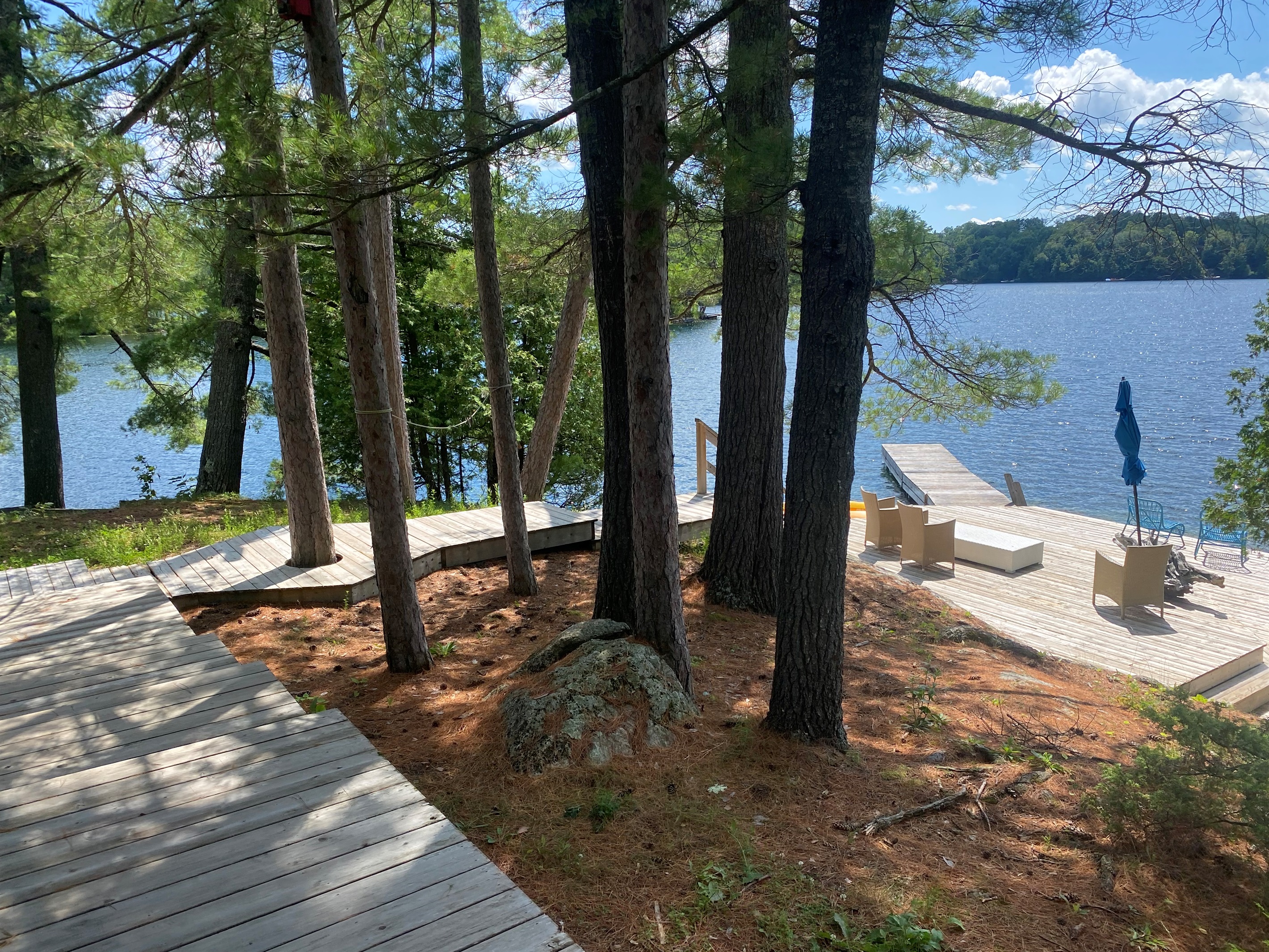 View of dock area, deck and steps down to water from cottage