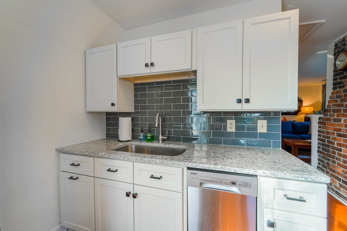 Fully stocked kitchen with a dishwasher, and garbage disposal. 