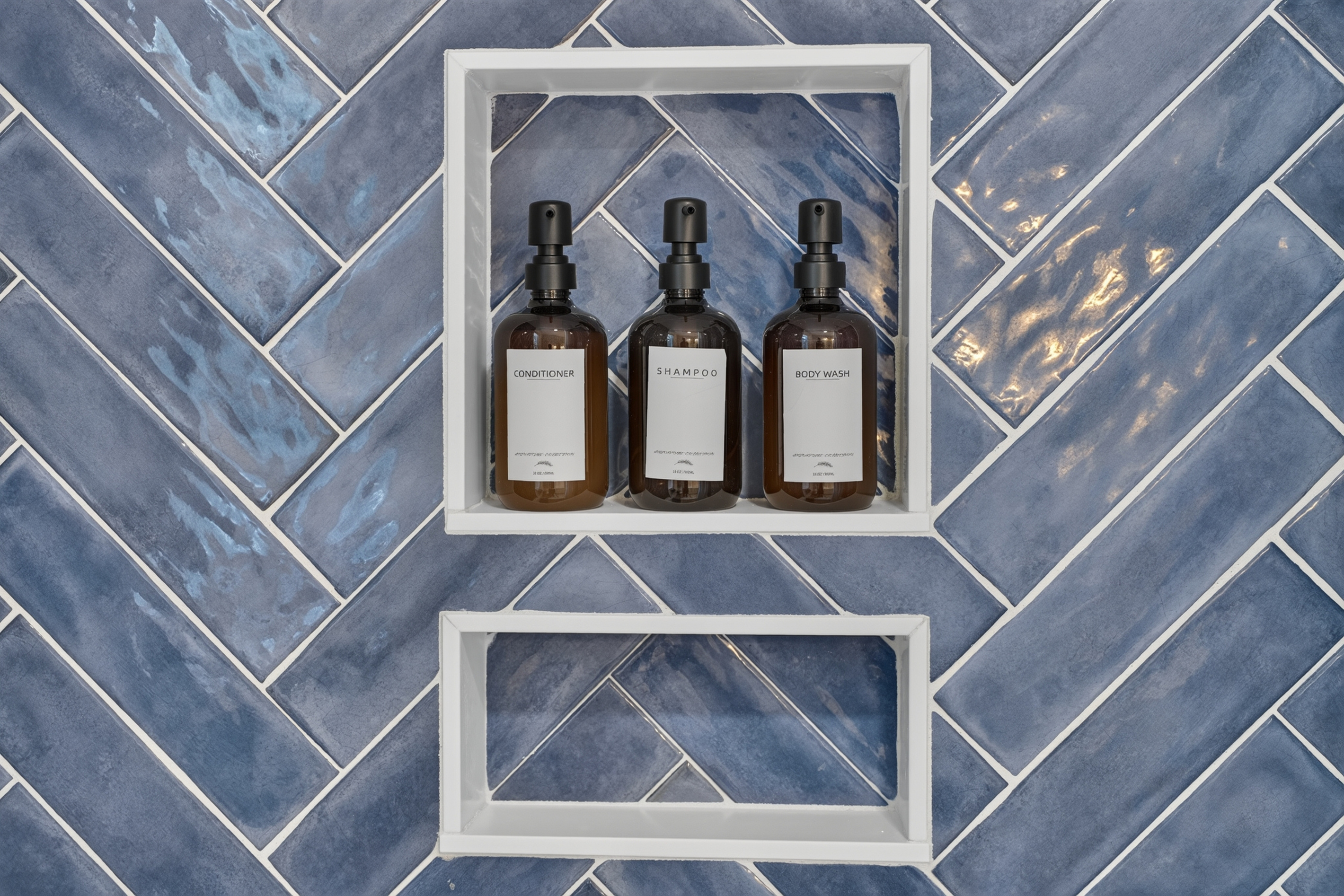 Beautiful walk-in shower featuring stylish tile and a built-in niche for toiletries.