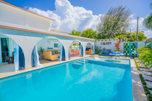 Here is the view from the deep end of the pool looking back towards the hot tub, al fresco dinning, seating area, and outdoor kitchen.