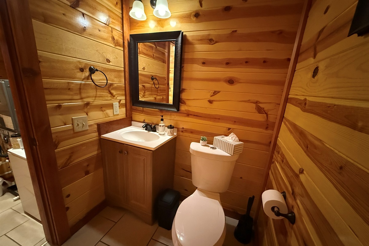 Located just down the hall from the pool room, this powder room adds extra convenience—because every guest appreciates plenty of well-appointed bathrooms.