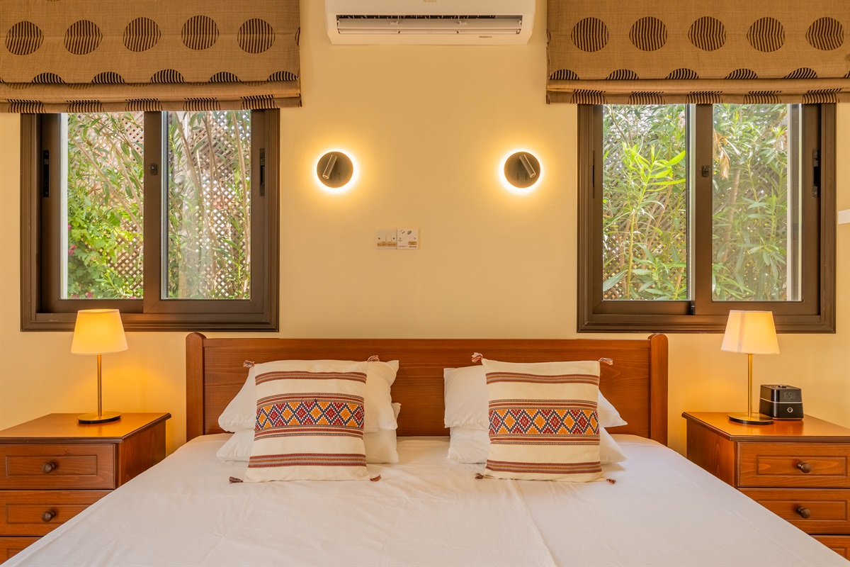 Second king bedroom with direct patio access. King size bed, ceiling fan, dedicated AC/heating unit, vanity, large built-in wardrobes, bluetooth speaker/alarm clock.