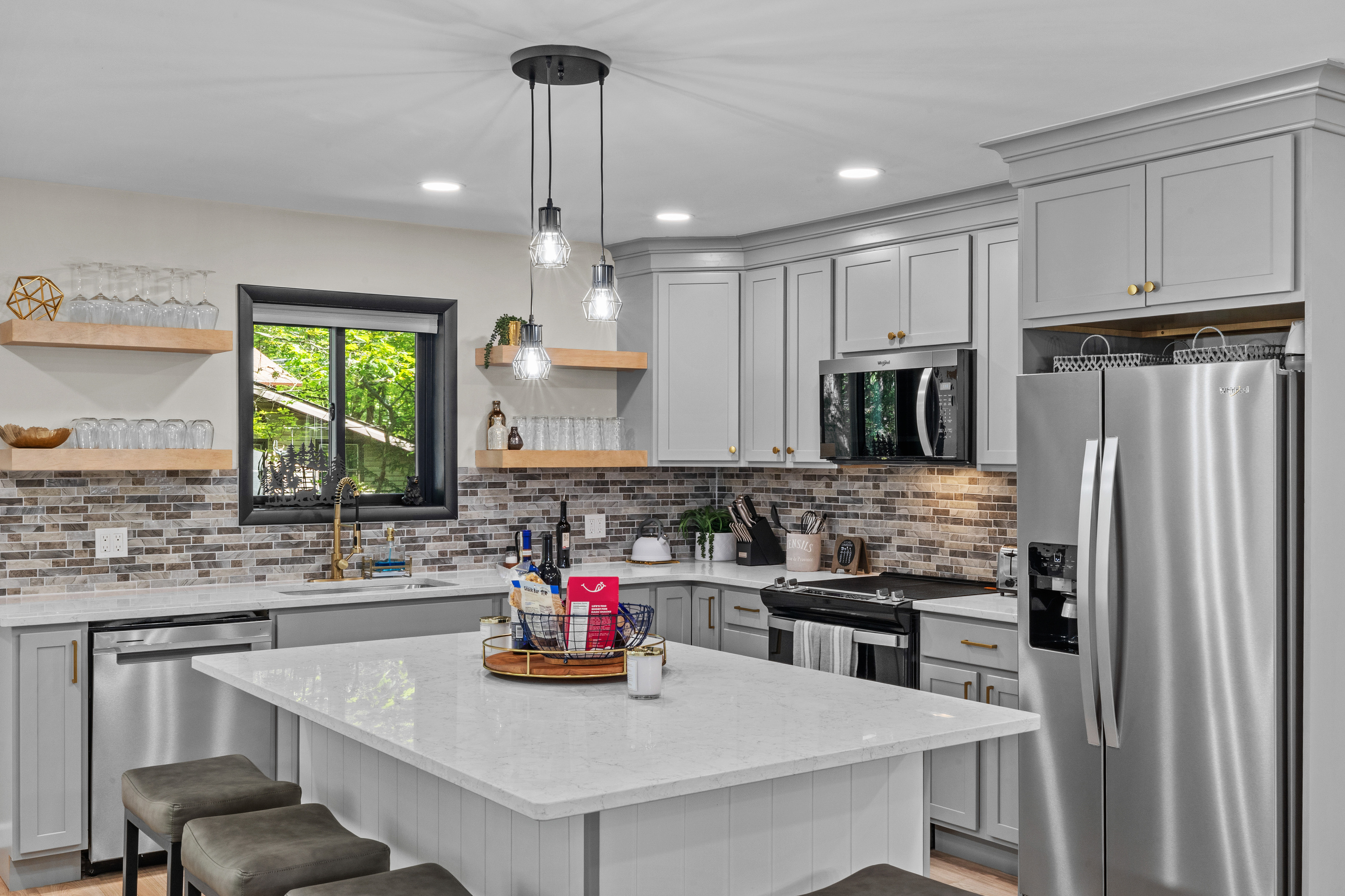 Wide, open-concept kitchen designed to comfortably accommodate multiple cooks preparing group meals together.