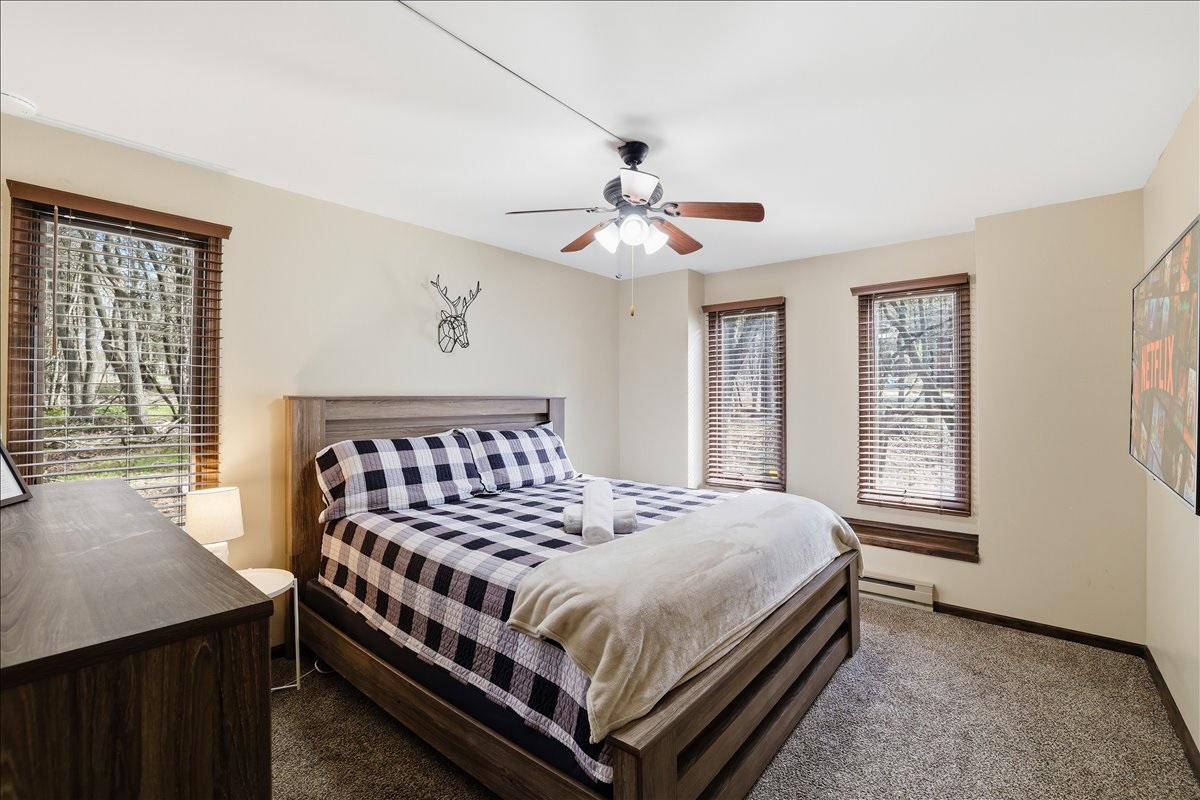 The main-floor king bedroom is a peaceful retreat. Plush bedding, blackout shades and your own TV