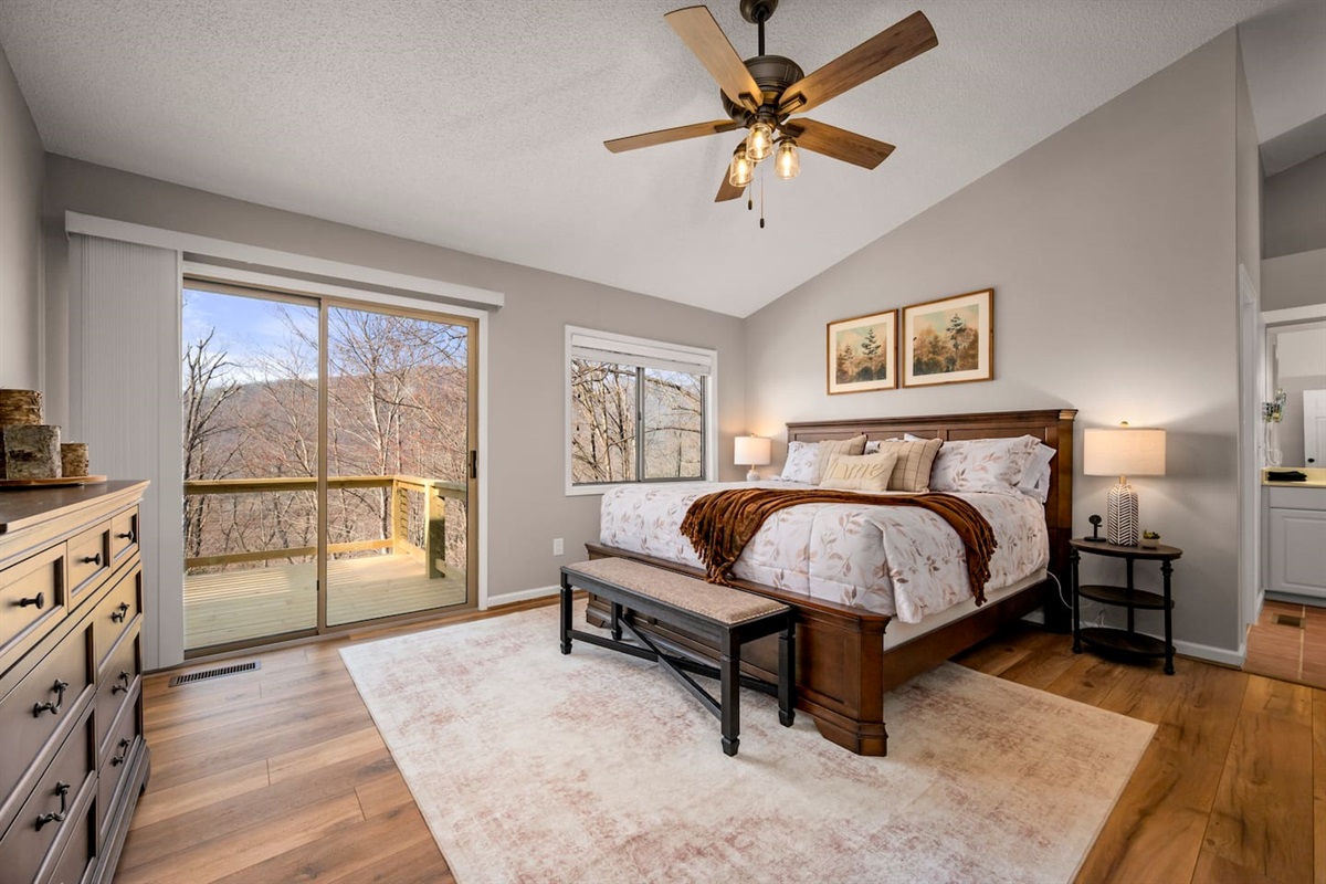 Bedroom #1 on main level of home with en suite bathroom and deck access 