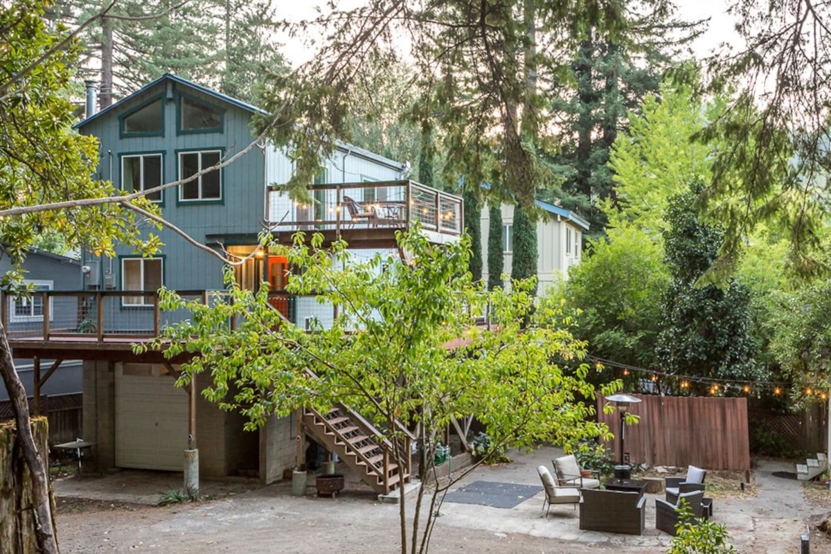 - Stylish multi level home with spacious decks for outdoor living  
- Ground level patio features cozy seating and a warm fire pit  
- Surrounded by towering trees for a serene, secluded retreat  