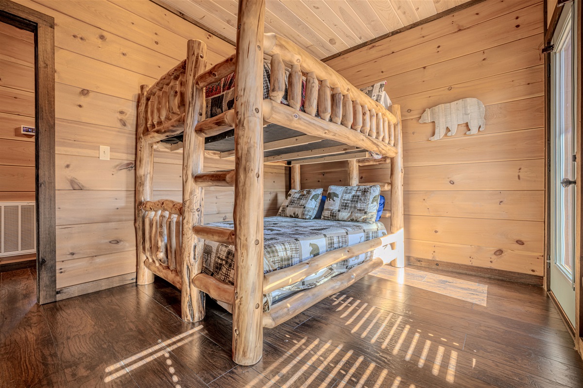 Fun bunk room perfect for kids, complete with lodge-style log bunks.