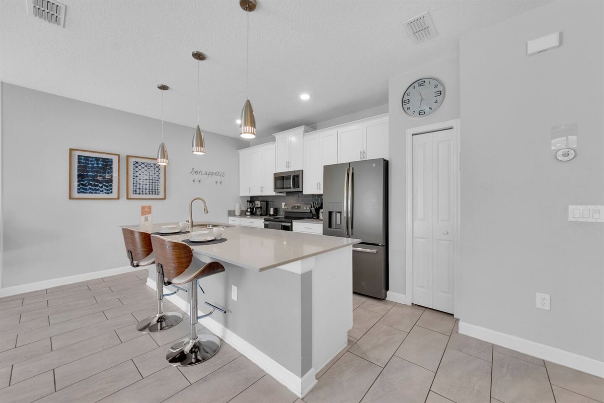 The open floorplan includes a fully equipped kitchen, overseeing the living and dining area, who leads to your private patio with pool