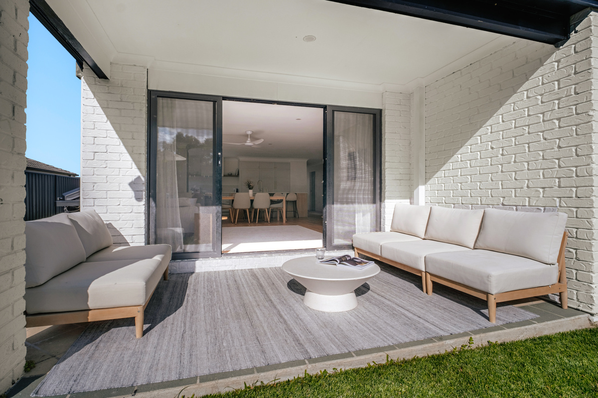 The patio seating fits 6–8 people and sits close to the lawn, BBQ area and sliding doors from the living room.